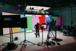 Film studio setup with lighting, camera gear, and colored backgrounds ready for production.