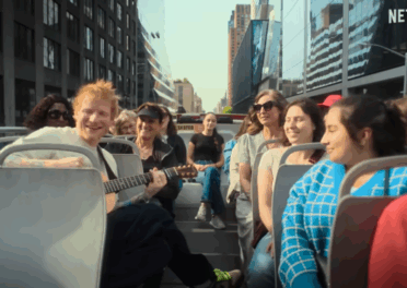 Crew and performers moving through Times Square during Ed Sheeran’s ONE SHOT production.