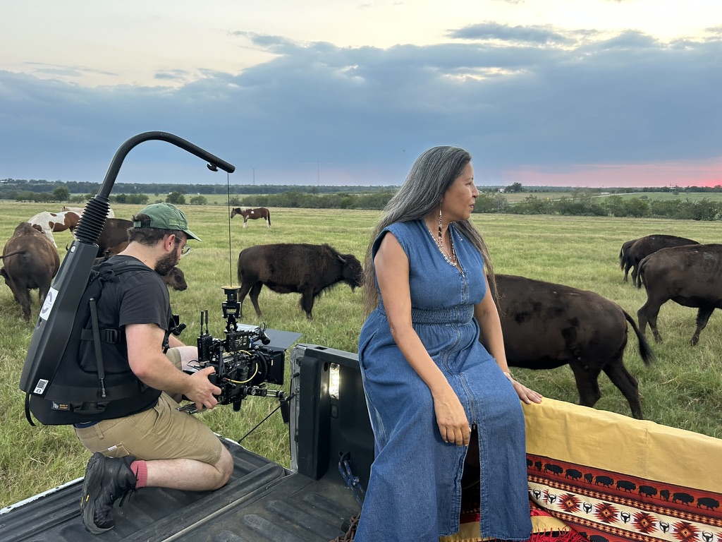 Film crew shooting documentary filmmaking behind the scenes with buffalo in remote location